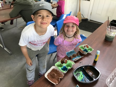 Boy and girl smiling doing crafts